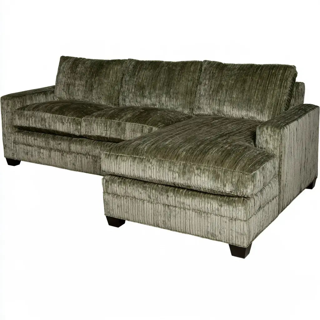 Green sectional sofa with elongated seat and large cushions from CenterpiecePoint Collections, showcasing a comfortable modern living room.